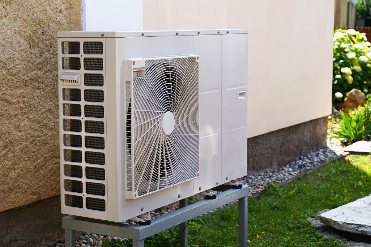 Outdoor air conditioning unit installed beside a home.