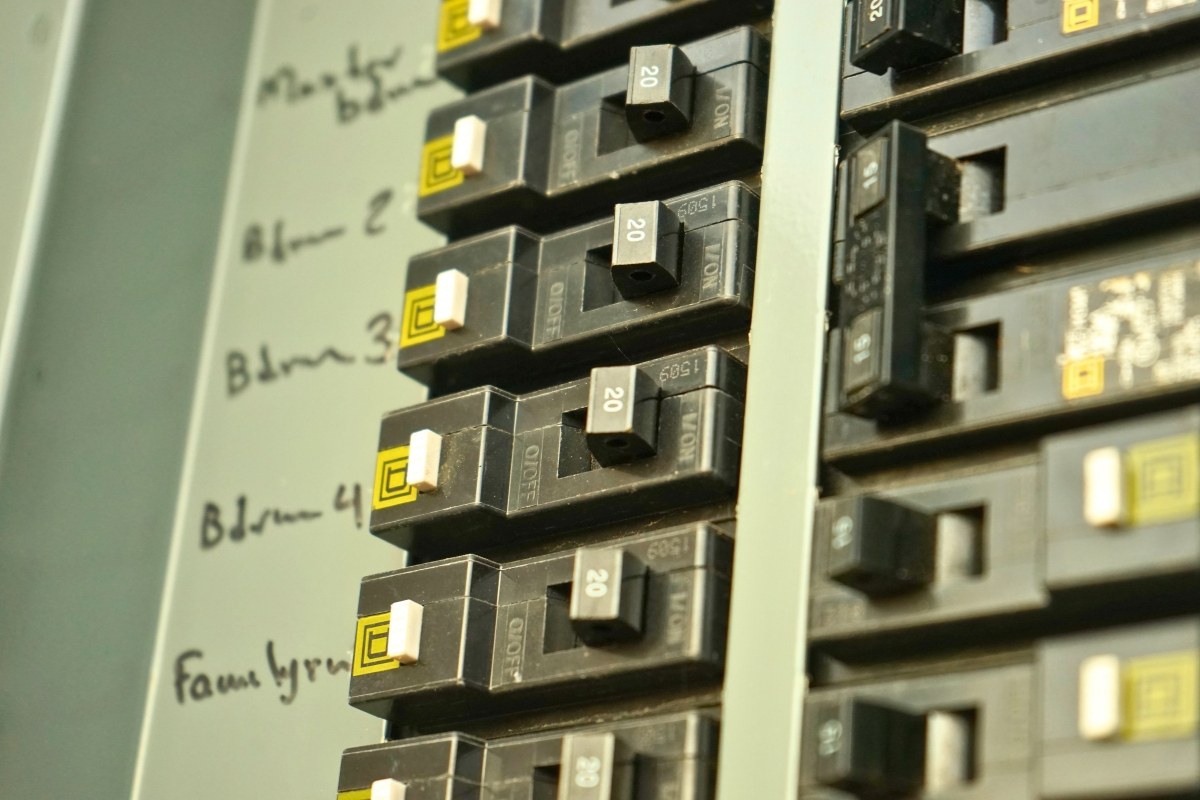 Close-up of electrical breaker panel, illustrating common issues when ac breaker keeps tripping.