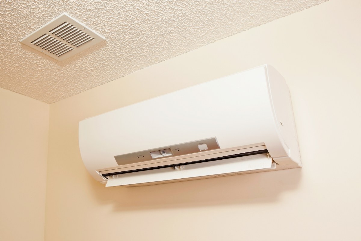 Modern white mini split air conditioner installed on a wall, showcasing a popular option when considering are mini splits worth it.
