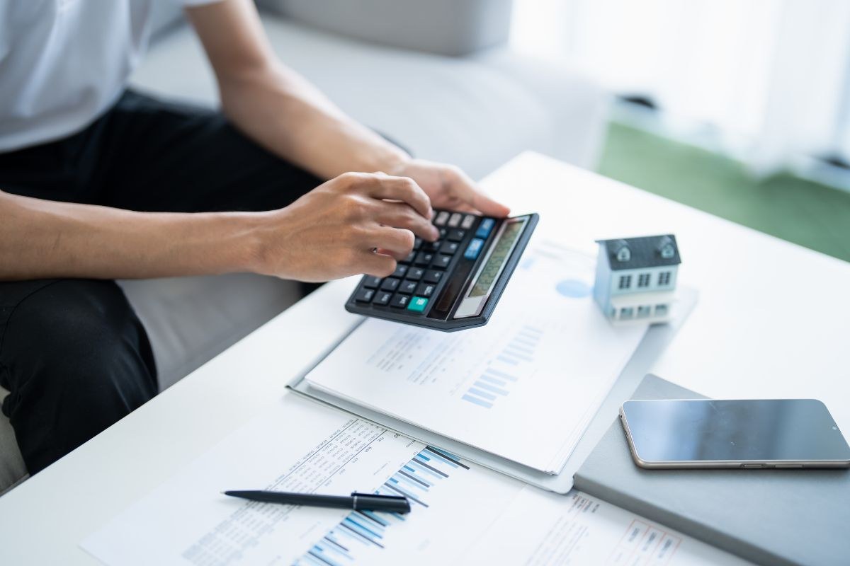 The man is calculating his monthly bill.