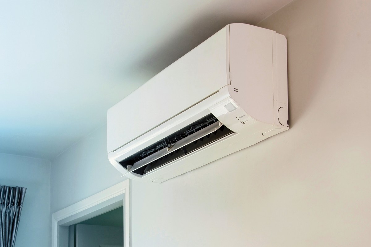 Modern white Freon AC unit installed on a wall in a home interior.