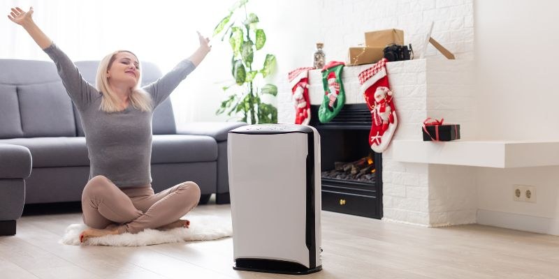 The woman feels comfortable after having a dehumidifier.