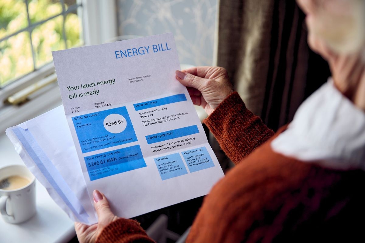 The older woman is checking to see if her electricity bill is going down.