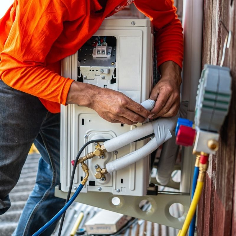 HVAC technician repairing a ductless mini split air conditioning system