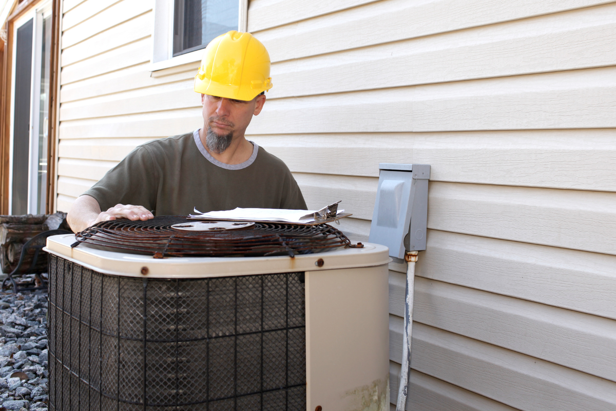 An AC tech repairs a unit that blows air but doesn't cool.