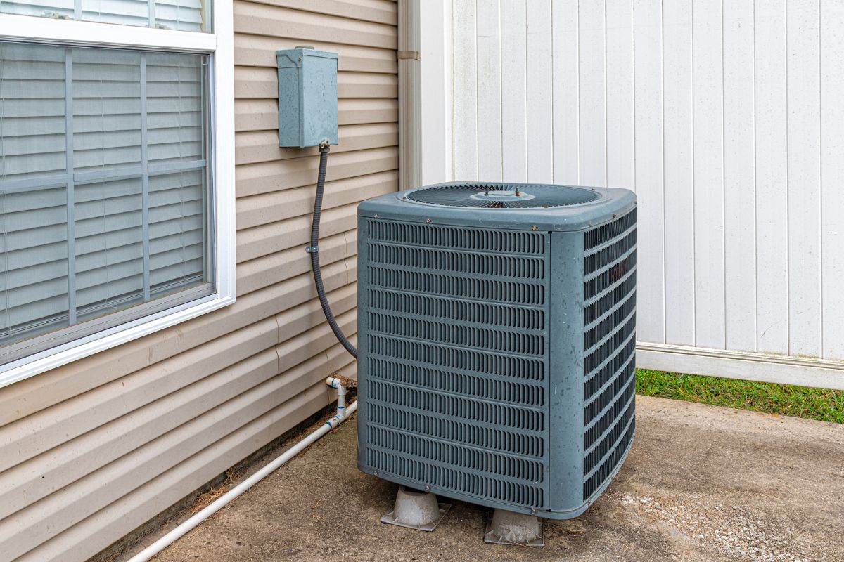 A central AC unit installed beside a home in South Florida.