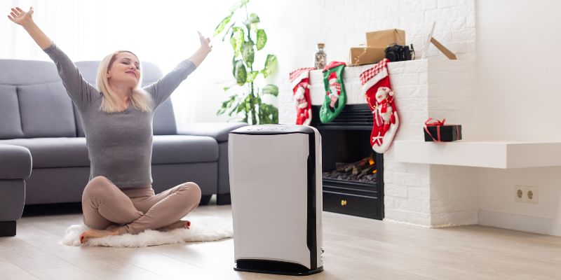 The woman feels comfortable after having a dehumidifier.