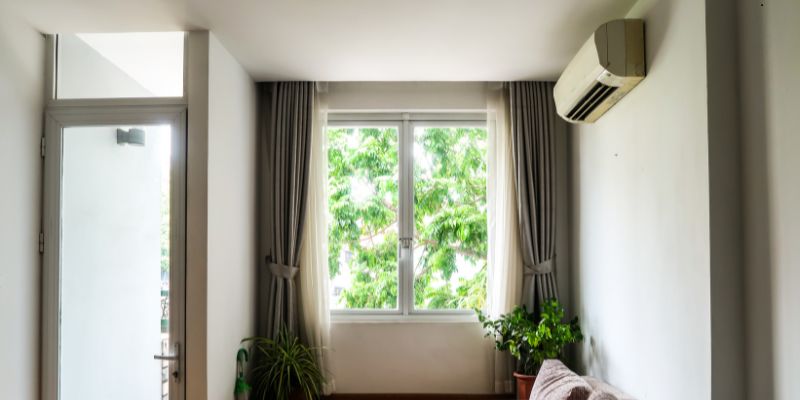 Wall-mounted air conditioning unit used to show the pros and cons of mini splits.