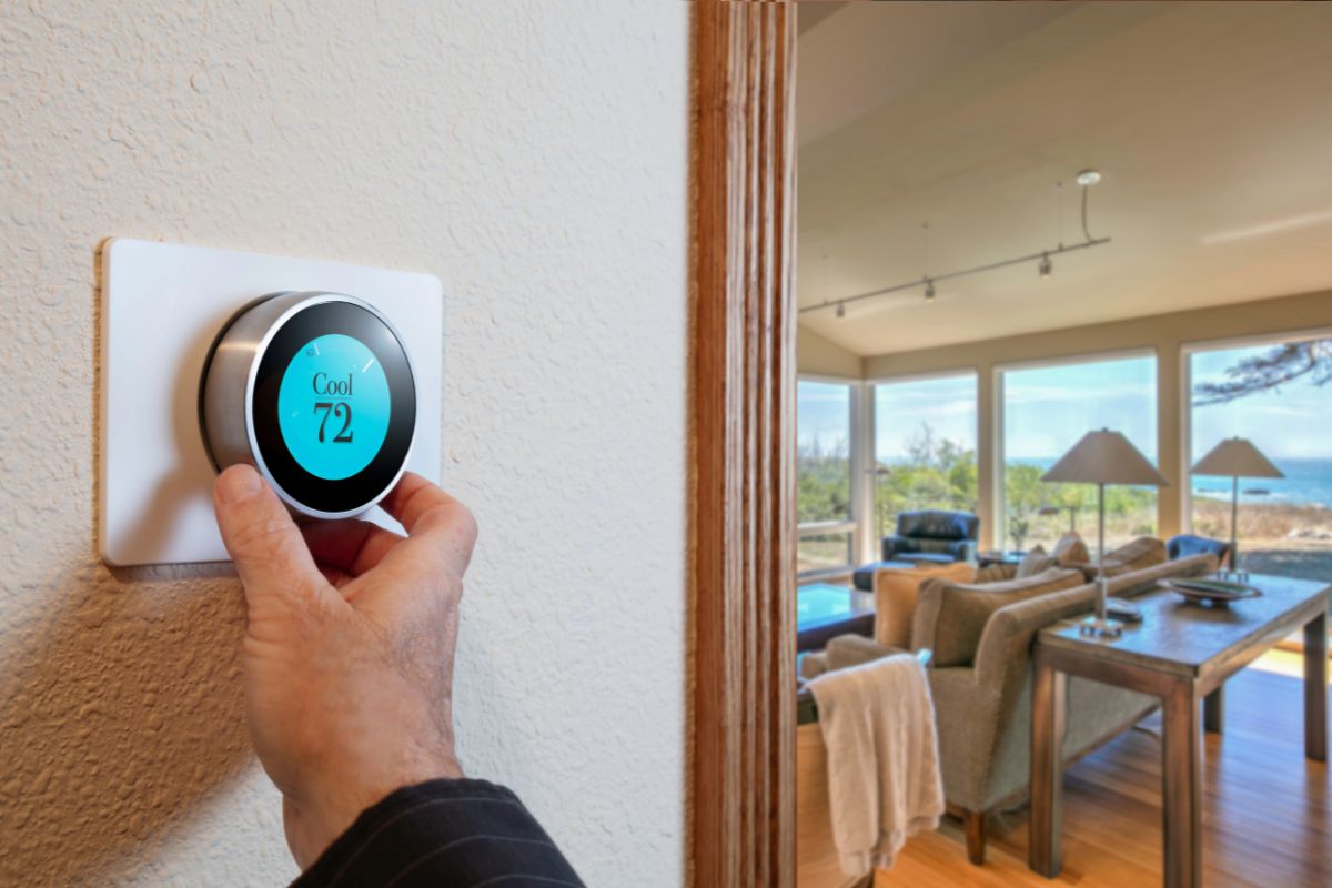 The homeowner adjusts the thermostat setting to an ideal setting for summer.