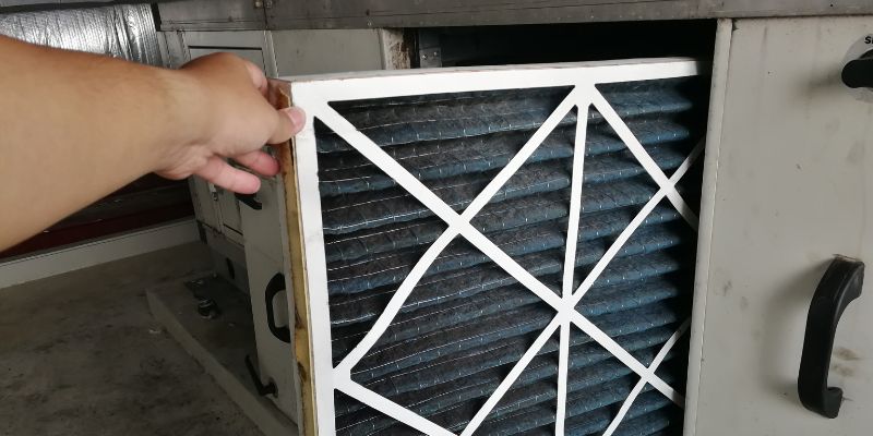 The HVAC technician checks the air filters.