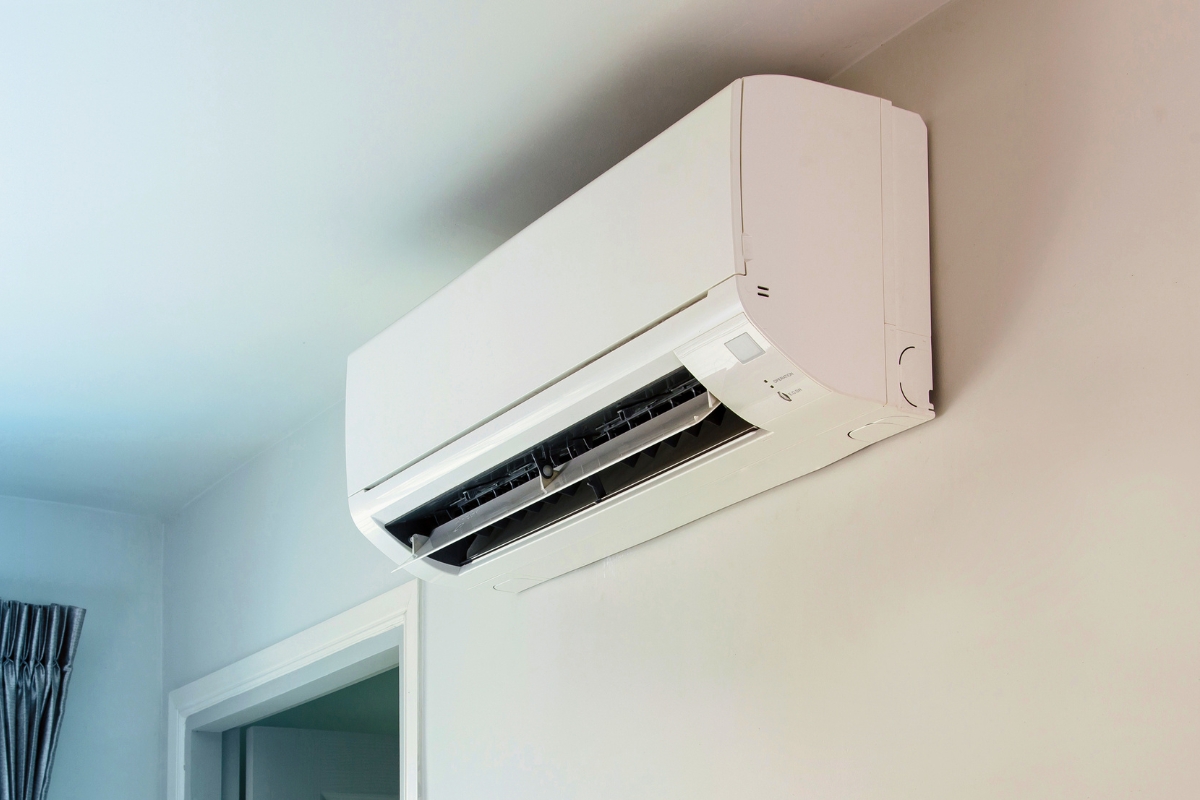 Modern white Freon AC unit installed on a wall in a home interior.